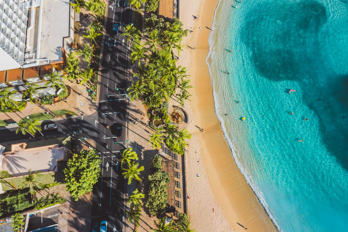 quiet beach towns in the US with a scenic coastal road, palm trees, and clear blue water