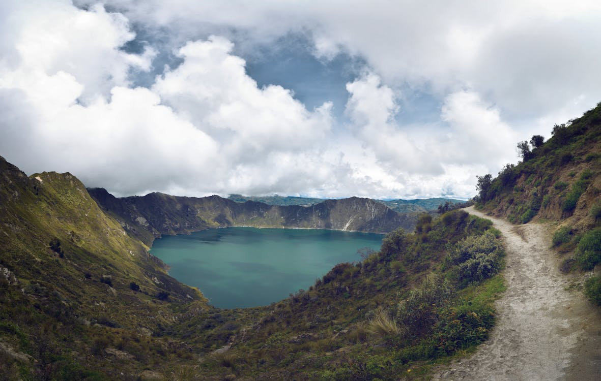 Why do lakes explode shown through a volcanic crater lake surrounded by steep mountain slopes.
