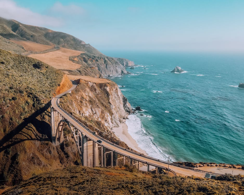 scenic coastal drives with a winding cliffside road, ocean views, and rugged shoreline